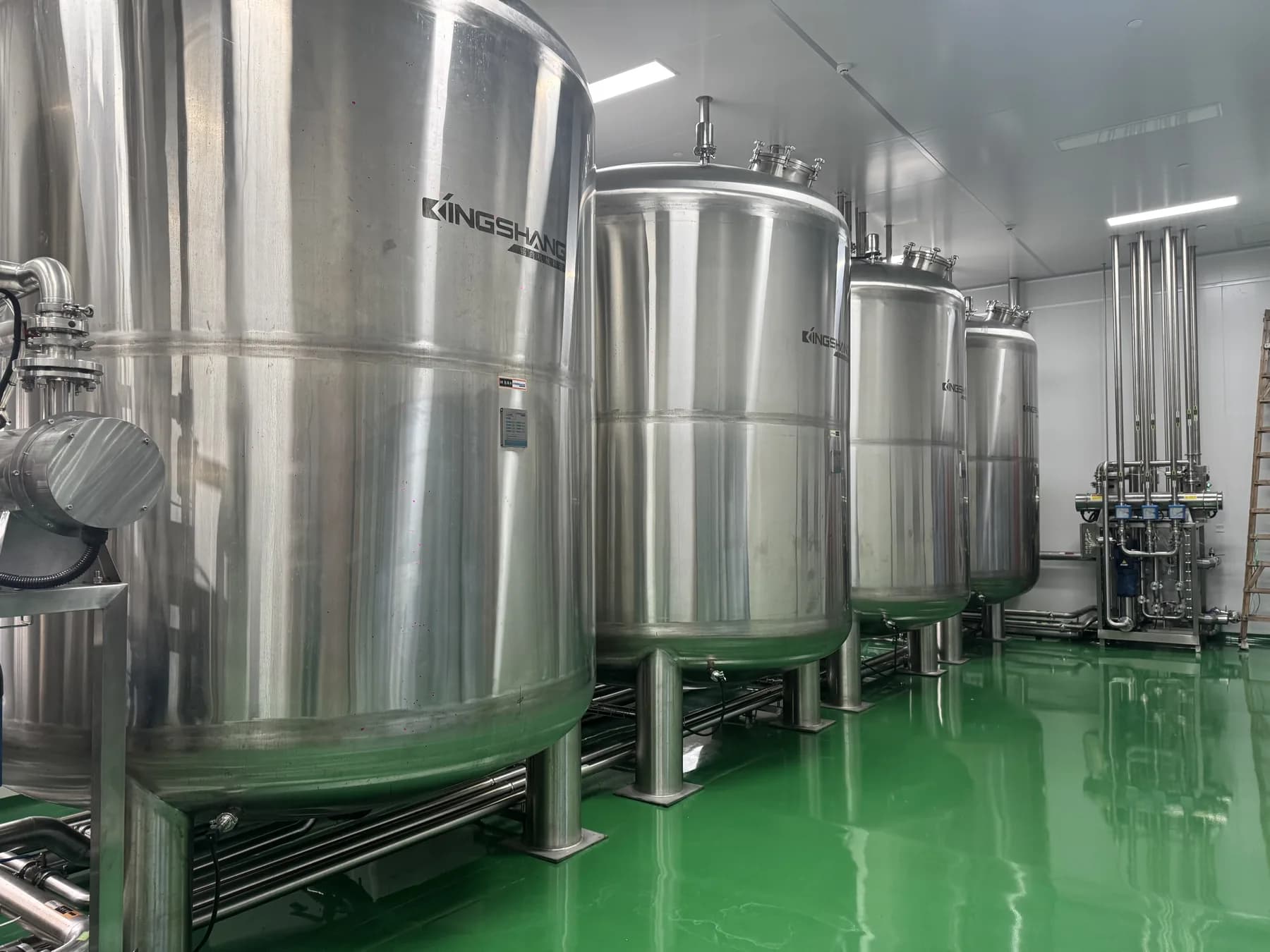 Large stainless-steel vessels used for cosmetic formula preparation at King Metis
